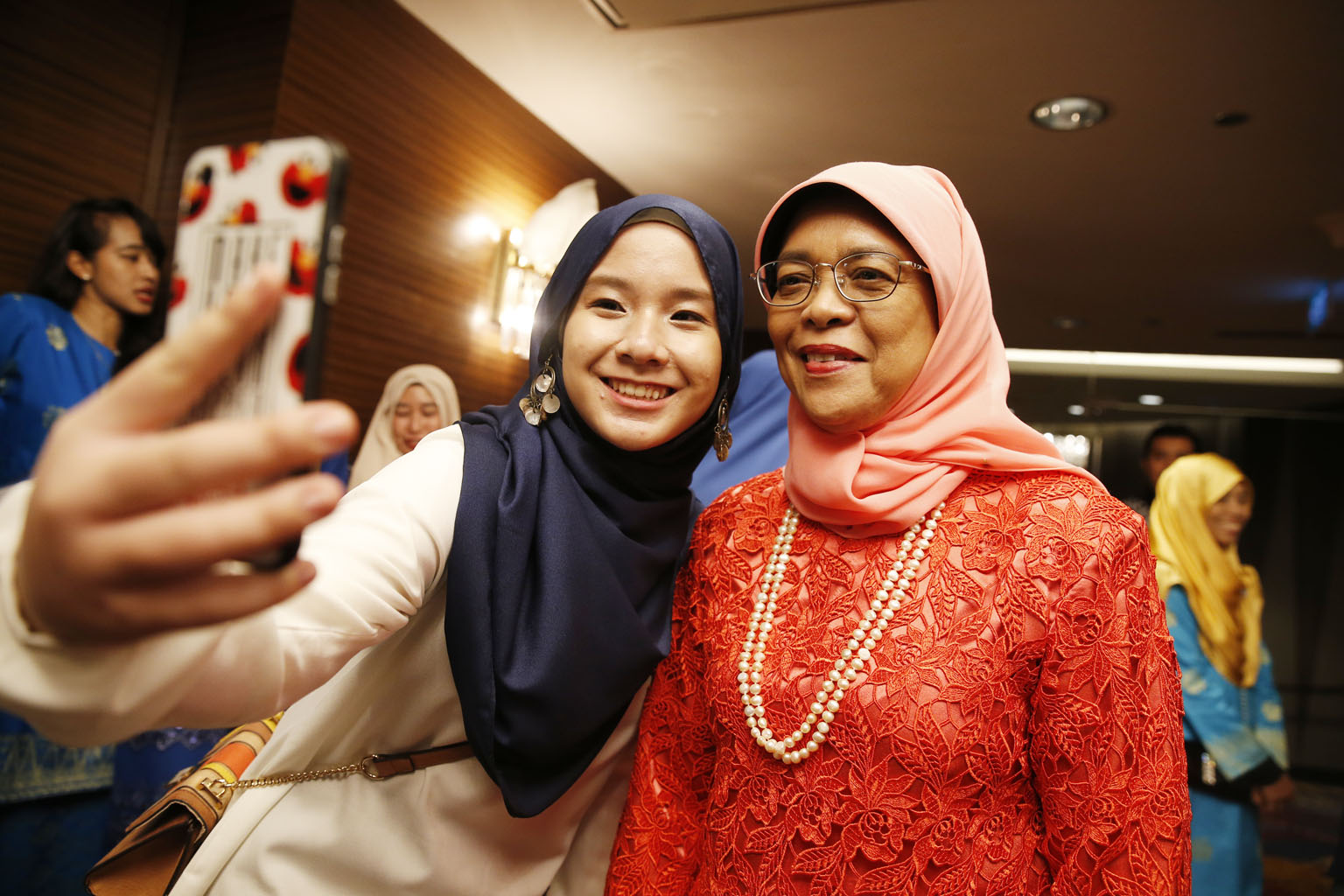 President Halimah Yacob taking a selfie with intern Nur Hazwani, 22, at a dinner to celebrate the 70th anniversary of the Malay Youth Literary Association (4PM) at Mandarin Orchard last night. The eventpaid tribute to 4PM's volunteers for their dedic