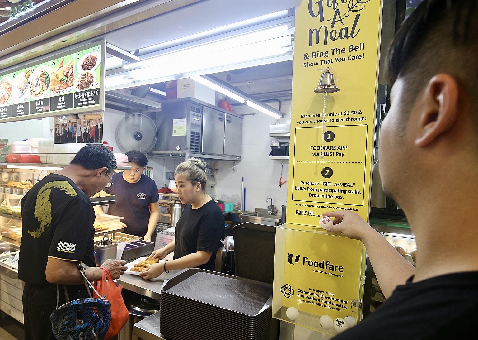 Diners can donate a meal by buying "Gift-A-Meal" balls from stalls in Pasir Ris Central Hawker Centre and dropping them in a box.