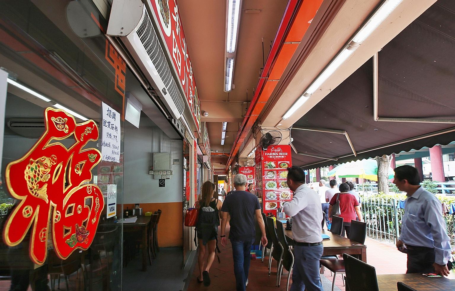 Shoppers and tourists walking past restaurants in Chinatown. A forum at the URA Centre discussed the challenge of balancing commercial interests with cultural ones in the precinct, and its evolving role.