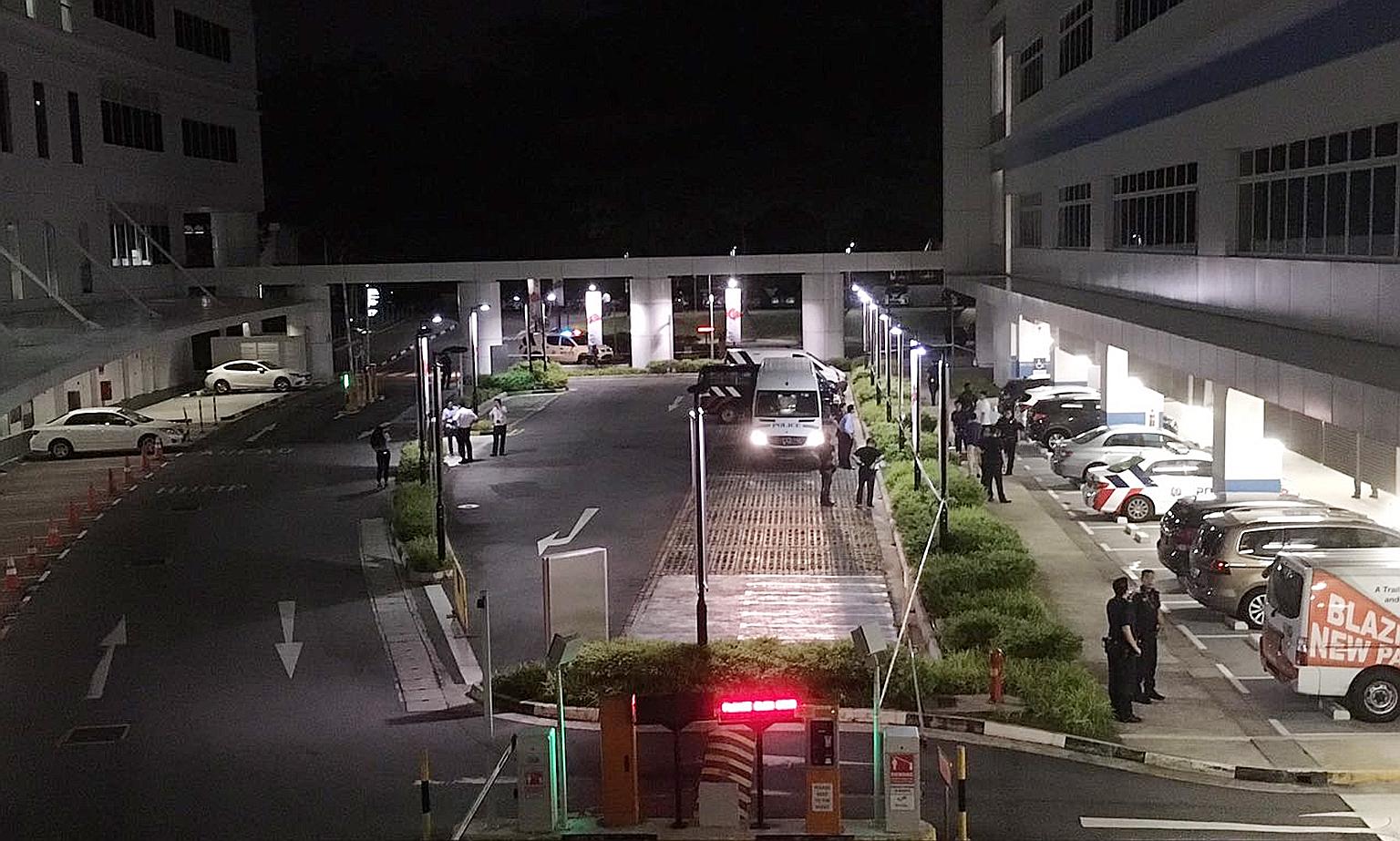 Police officers at the entrance to the sheltered carpark of ITE College Central in Ang Mo Kio, where a woman was believed to have been stabbed to death last night.