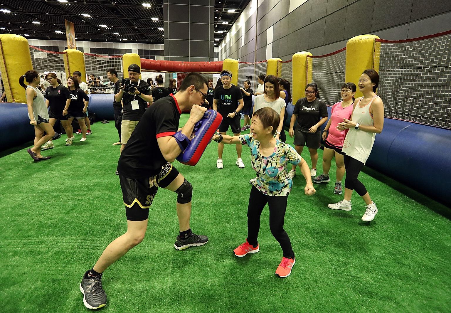 Participants at a free muay thai class during Feel Fab Fest 2018 yesterday. Organised by Singapore Press Holdings, the festival offers activities and discussions that promote a healthy lifestyle.