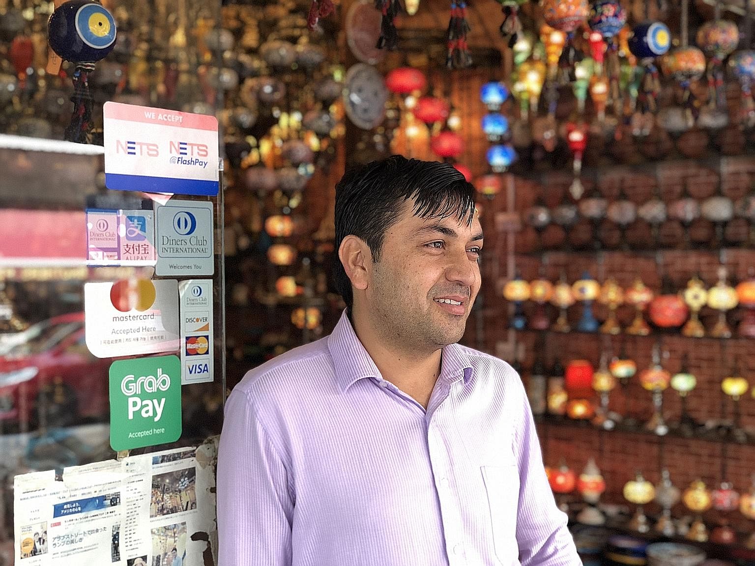 Mr Faizullah Saadullah operates family-owned retail shop Sufi Trading, which has used the GrabPay platform for three months and adopted Alipay recently. Mr Faizullah says the Alipay platform allows the Arab Street shop, which sells Turkish lamps, han