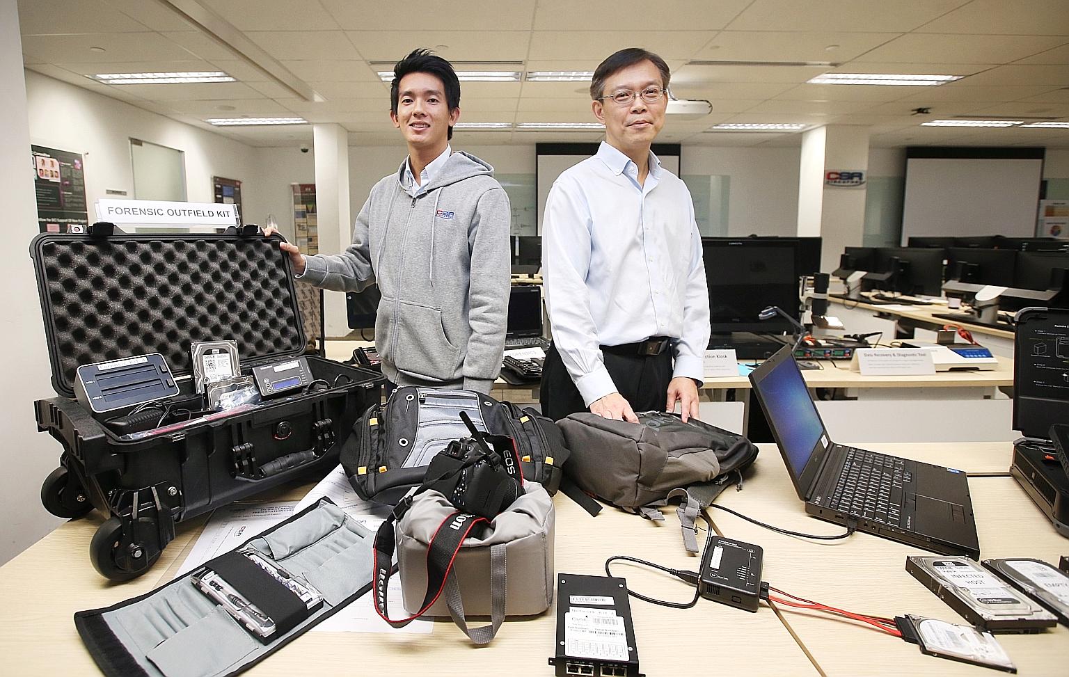 CSA National Cyber Incident Response Centre director Dan Yock Hau (right) and CSA senior consultant Lin Weiqiang with the forensic toolkits used to gather evidence at SingHealth's premises on the day of the attack. The equipment allows investigators 