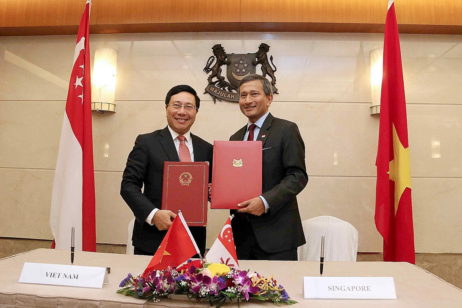 Vietnam's Deputy Prime Minister and Foreign Minister Pham Binh Minh (left) and Foreign Minister Vivian Balakrishnan after signing the agreement on the Vietnam-Singapore Cooperation Centre yesterday.