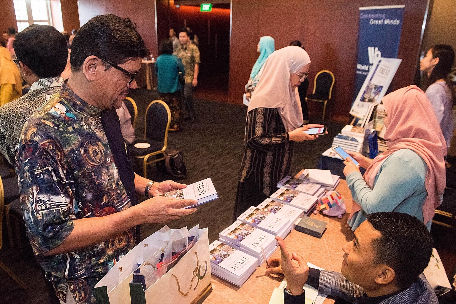 People visiting the selling booth to buy the Muis' 50th anniversary book, Fulfilling The Trust: 50 Years Of Shaping Muslim Religious Life In Singapore, during its launch at the Asian Civilisations Museum yesterday.