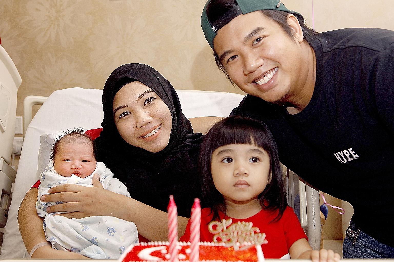 Ms Nuraidillah Rapi'e and Mr Firman Akhfar Ismaal with their two-year-old daughter Nurdaneya Filza and newborn son Muhammad Aqil Fayyadh, both of whom were born on National Day.