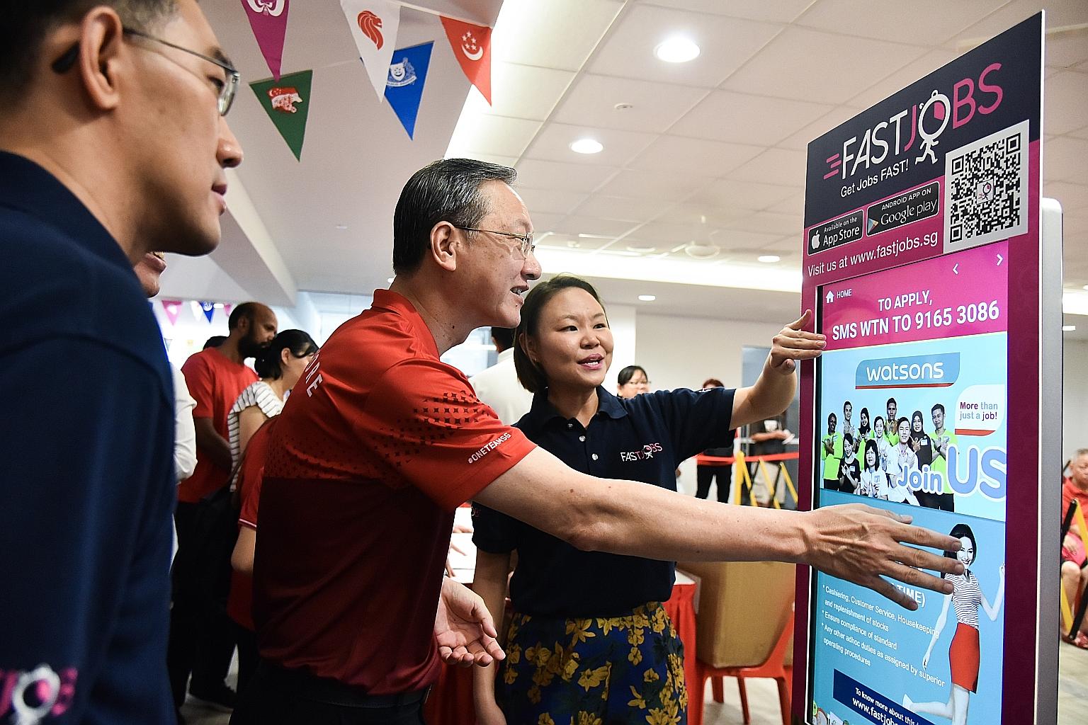 Ms Joelle Pang, start-up FastJobs' regional business development director, showing Radin Mas MP Sam Tan how to use a FastKiosk at the Radin Mas Community Club yesterday. The kiosk lists job vacancies in the Radin Mas neighbourhood.