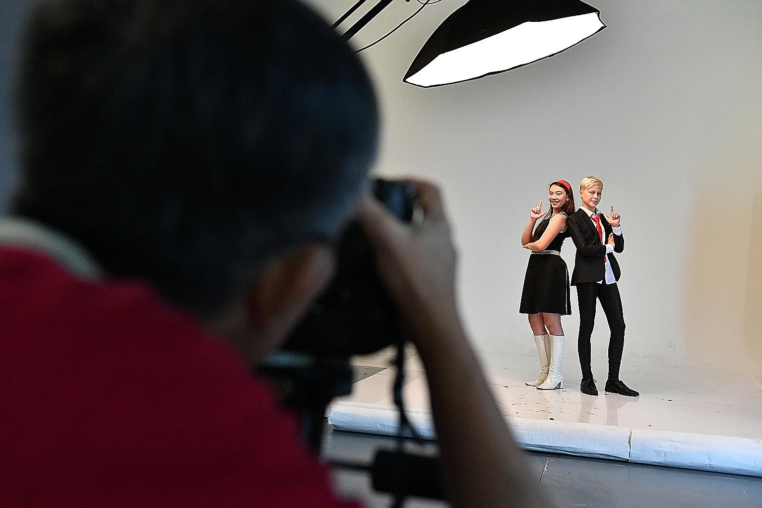 Singers Natasha Hui Min Bjerg, 14, and Bastien Buwalda, 13, striking a pose for the cameras as they prepare for a photo shoot for this year's ChildAid concert. The annual charity concert in November will be taking a trip down memory lane and showing