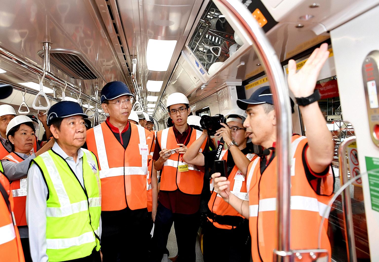 Transport Minister Khaw Boon Wan (far left) and new SMRT chief executive officer Neo Kian Hong (beside him) at the pre-launch of the new trains at Bishan depot yesterday.