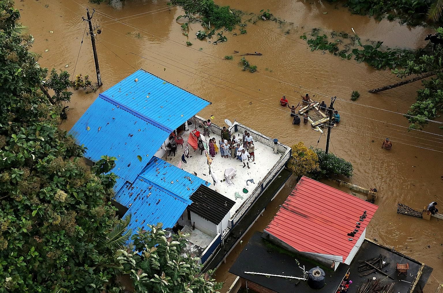 Thousands of people have been trapped by the worst floods to hit the southern Indian state of Kerala in a century. Some residents were spotted yesterday up on the roof waiting to be rescued. The death toll from the floods jumped to 324 yesterday, whi