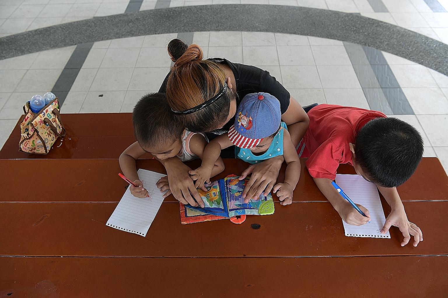 Housewife Shaodah Roslan, 28, with three of her seven children. Her husband works odd jobs and brings home up to $700 a month.