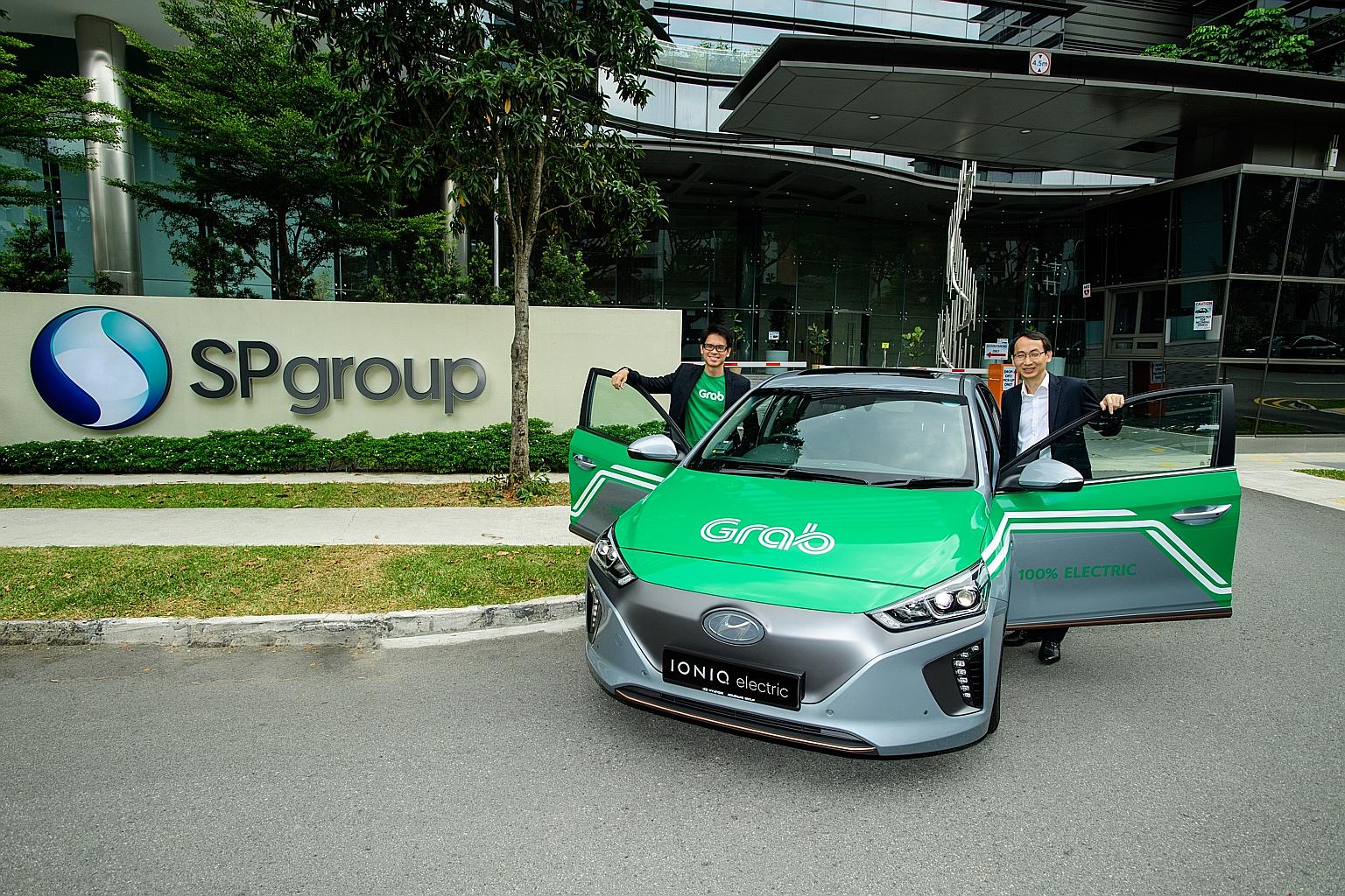 SP Group's Mr Goh Chee Kiong (right) and Grab's Mr Lim Kell Jay with a Hyundai Ioniq electric car. Grab says that it will give more details of the 200 electric cars later this year.