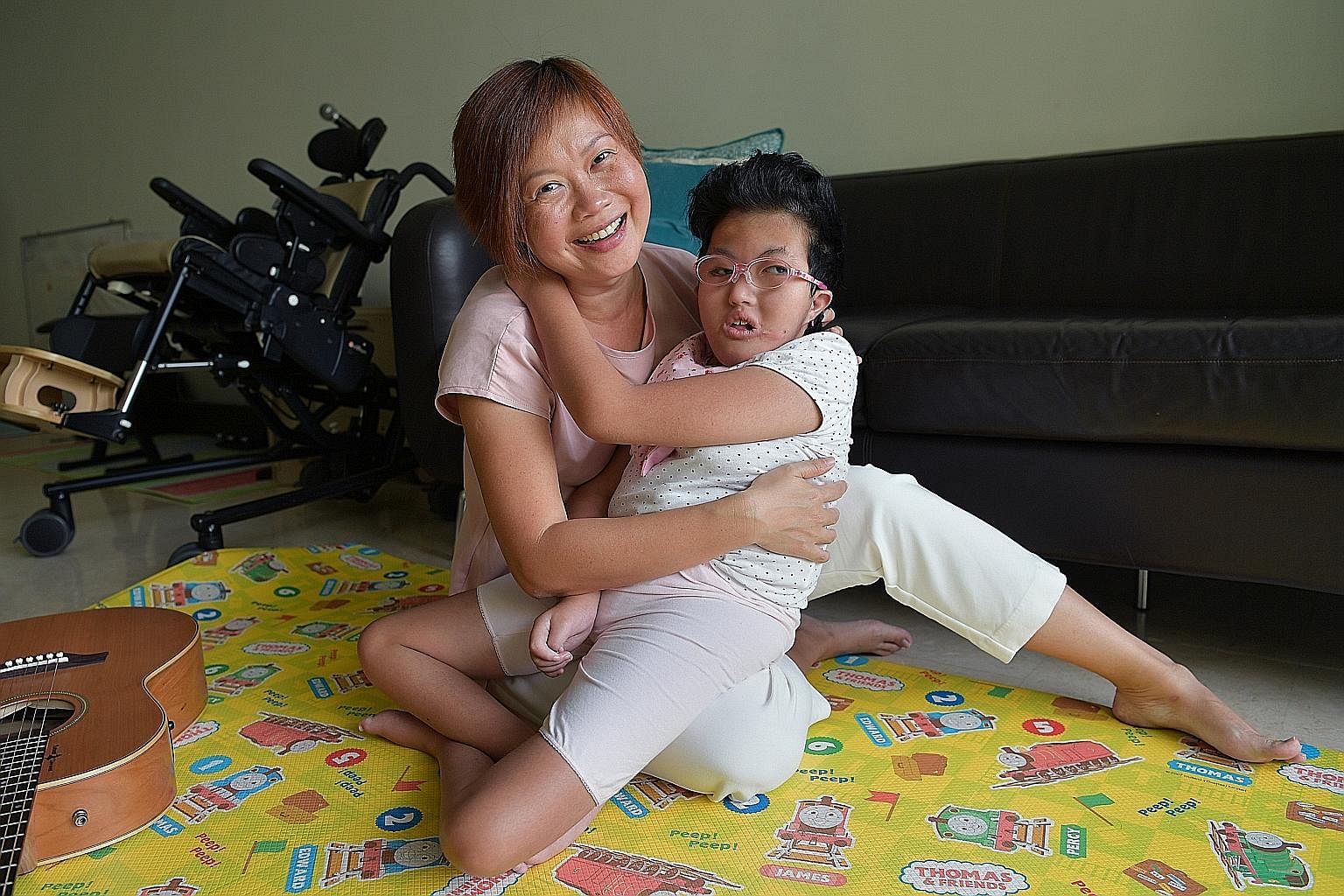 Ms Tham Yin May and her daughter Vera, who was born with a rare genetic disorder that resulted in her having a lateral cleft palate and defects of the brain, heart, stomach, airway, spine, ears, fingers and feet. Vera cannot talk, walk or swallow, an