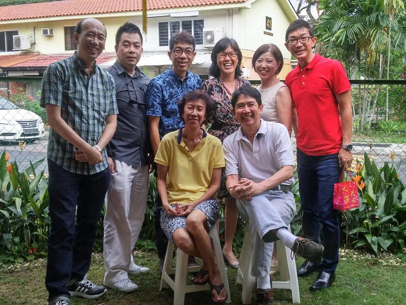 Mr Raymond Tan (standing, second from left) and six other former pupils of Delta West School with their teacher Tan Siam Tiam (seated) at her Stirling Road home during Chinese New Year in 2016.
