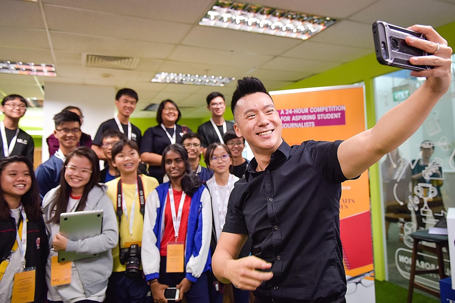 Actor Joshua Tan, who played the role of Ken Chow in the Ah Boys To Men movie series and is a youth ambassador for the National Council on Problem Gambling, taking a wefie with participants of the media competition yesterday. The participants had to 