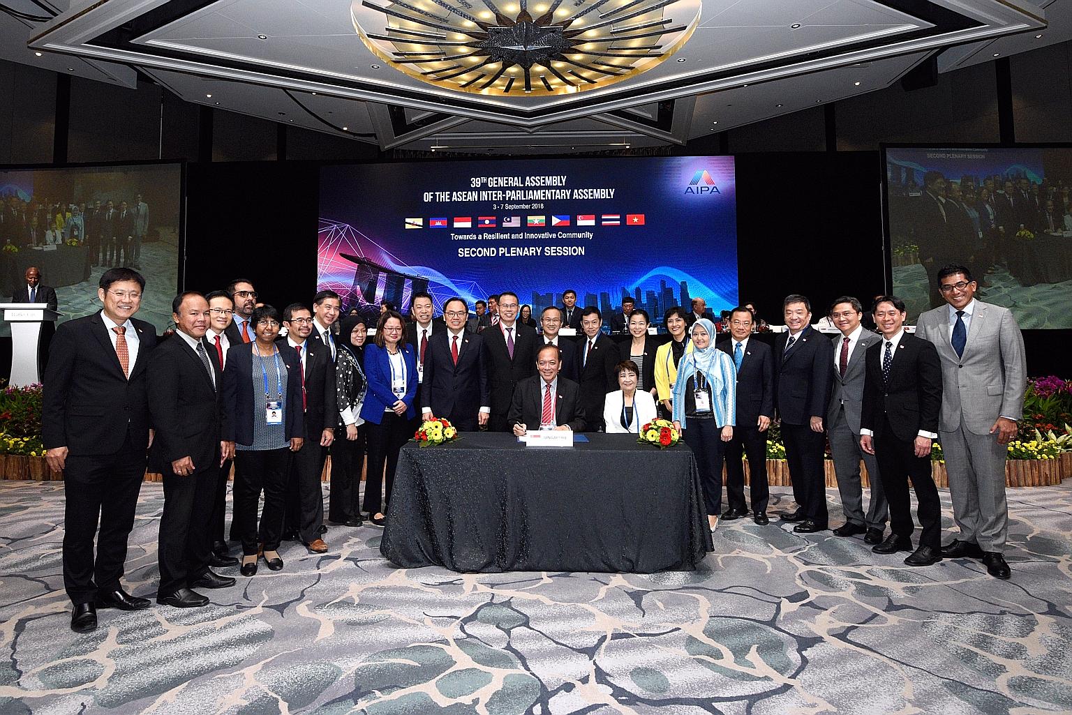 Mr Charles Chong (seated, centre), leader of the Singapore delegation, along with the Republic's team at the signing of the Joint Communique for the 39th Aipa General Assembly yesterday.
