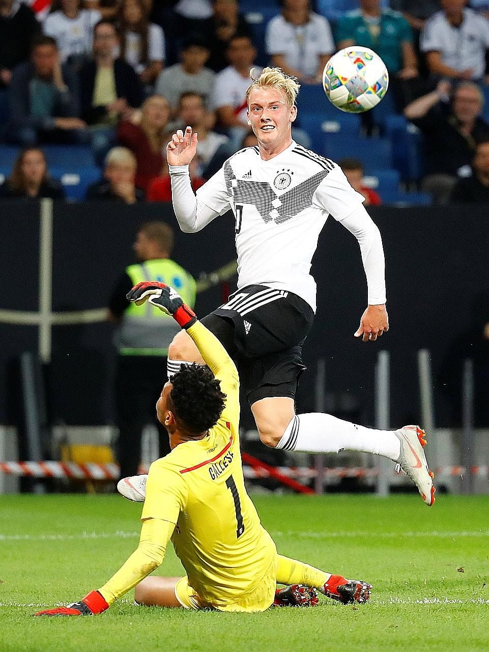 Germany's Julian Brandt lifting the ball over Peruvian goalkeeper Pedro Gallese to score their first goal during their international friendly. The Germans won 2-1 as they continued their rehabilitation following their group-stage exit at the World Cu