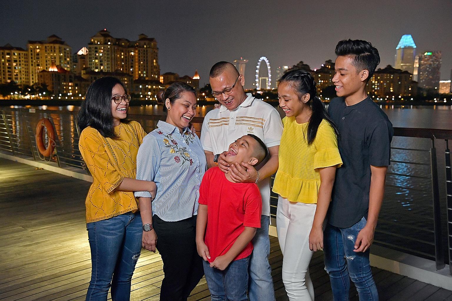 Madam Nurani Abdul Ghani and her husband Sairee Sinwan with their four children (from left) Syukrina, Nihal, Nusratina and Syabil.