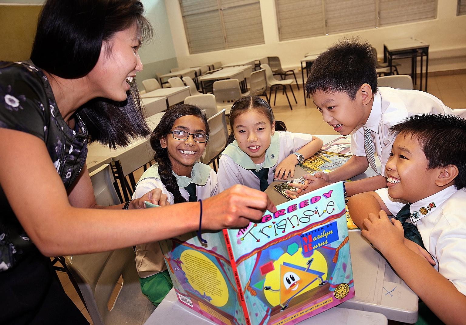 Woodgrove Primary pupils using storybooks in a mathematics class under the school's literature-based approach to the subject. The school has also turned its library into a MakerSpace, where pupils can sign up for sessions such as 3D design, stop-moti