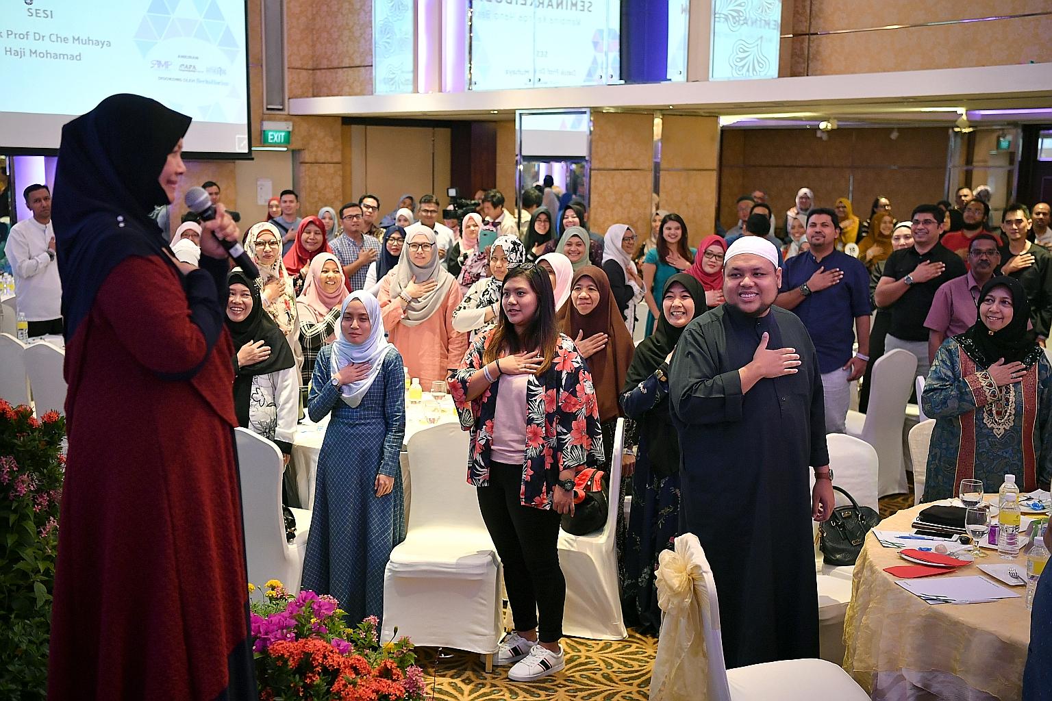 Motivational speaker Muhaya Mohamad (left) speaking at the parenting seminar organised by the Association of Muslim Professionals and the Centre for Fathering yesterday. The other speaker was Ustaz Zahid Zin (in white songkok), chief executive of Mus