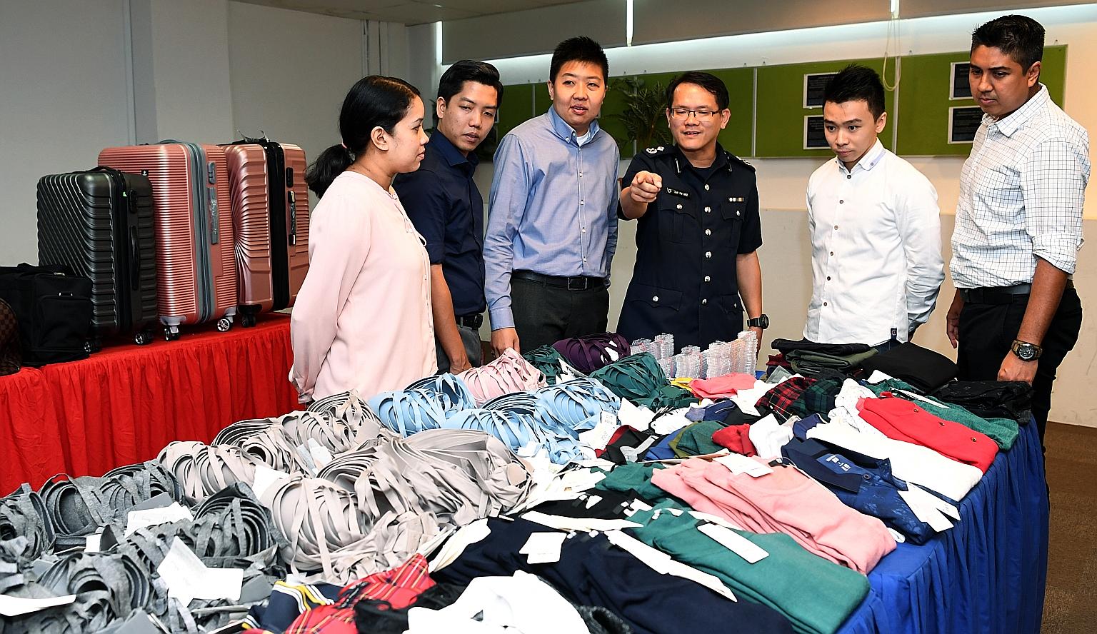 Assistant Commissioner of Police Tan Tin Wee (fourth from left) and officers who helped bust the syndicate with the stolen goods. The police described it as the largest shop theft case, in terms of value and volume, that they have come across in rece
