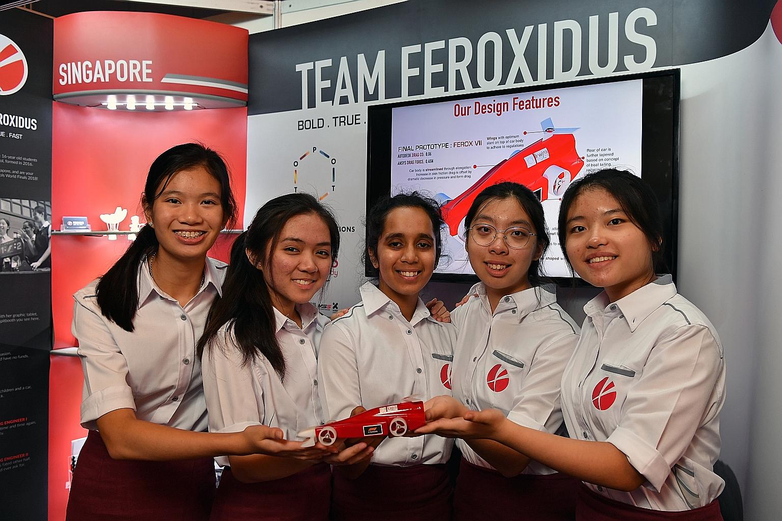 (From left) Nicole Lee, Kirsten Negapatan, Harshita Chauhan, Angeline Lai and Charisse Kwong of Raffles Girls' School showing off their car. They took part earlier this month in the world finals of the F1 in Schools competition, said to be a test of