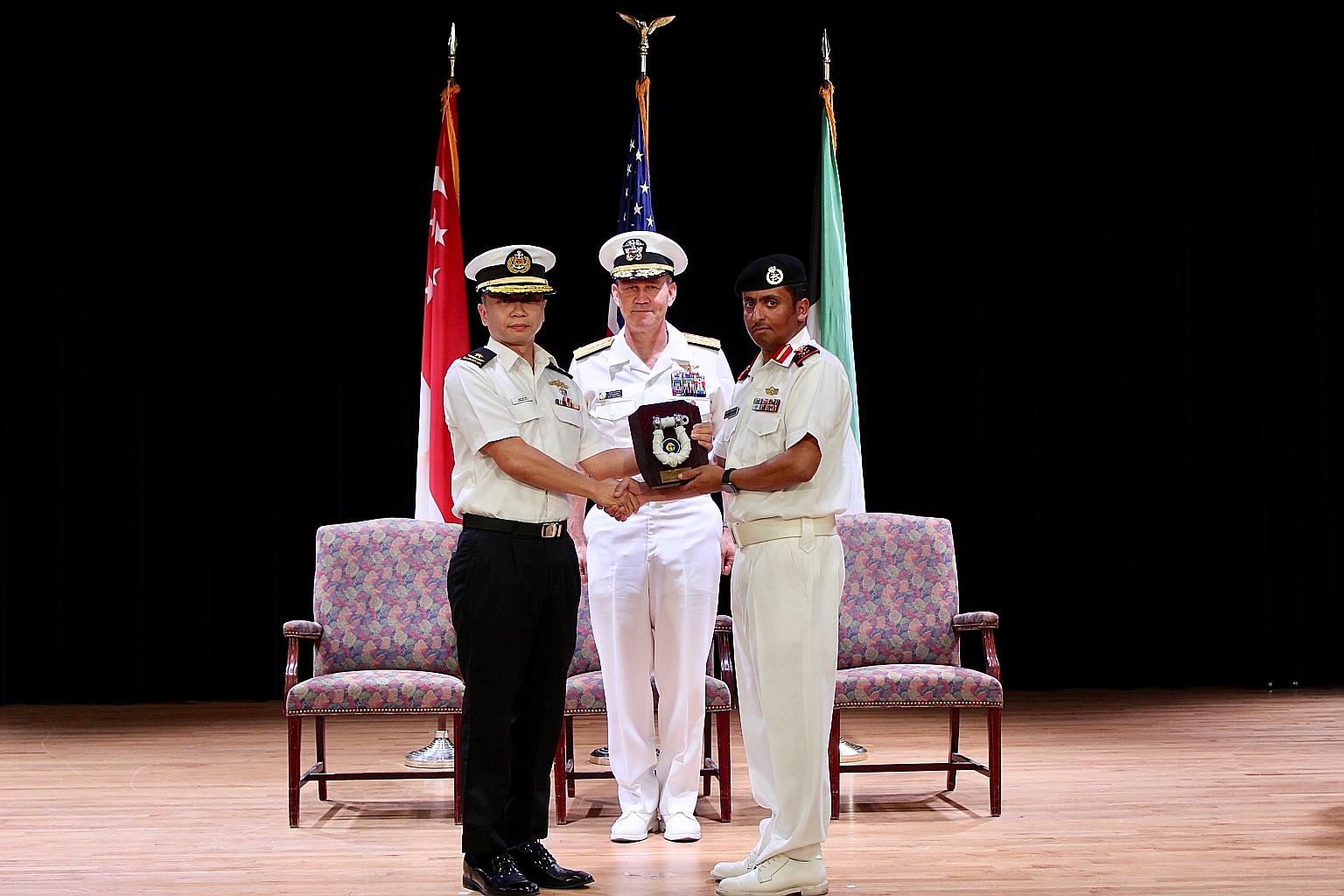 Rear-Admiral Saw Shi Tat handing over command of Combined Task Force 151 to Captain Ali Alrashidi of the Kuwait Naval Force in Bahrain yesterday, witnessed by Commander of Combined Maritime Forces US Vice-Admiral Scott A. Stearney.