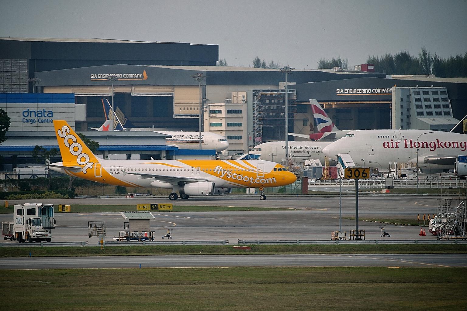 Above: One of the RSAF fighter jets that escorted Scoot Flight TR634 as it entered Singapore airspace on April 5, after passenger Hsu Chun Meng said he had a bomb in his bag. Left: The plane landed at a remote area away from the main Changi Airport t