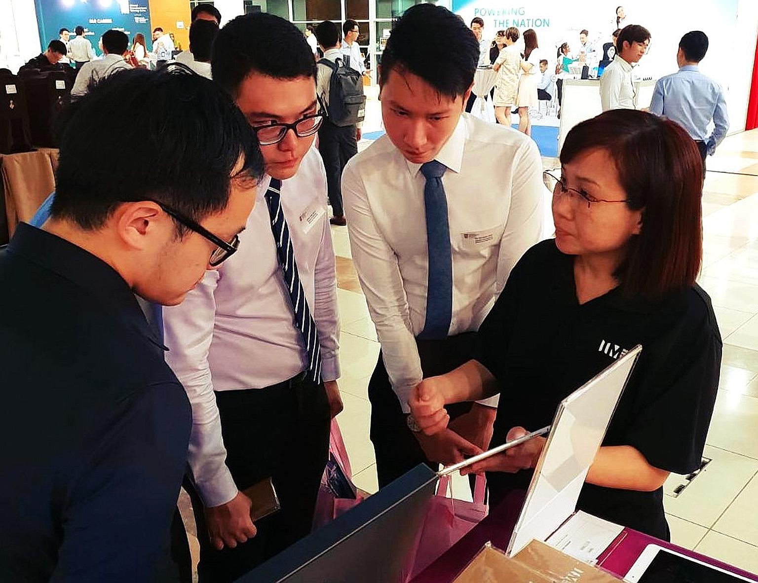 NTU students at the Infocomm Media Development Authority booth during NTUtopia, an invite-only career fair. One undergraduate said organisers had checked resumes and GPAs at the door.