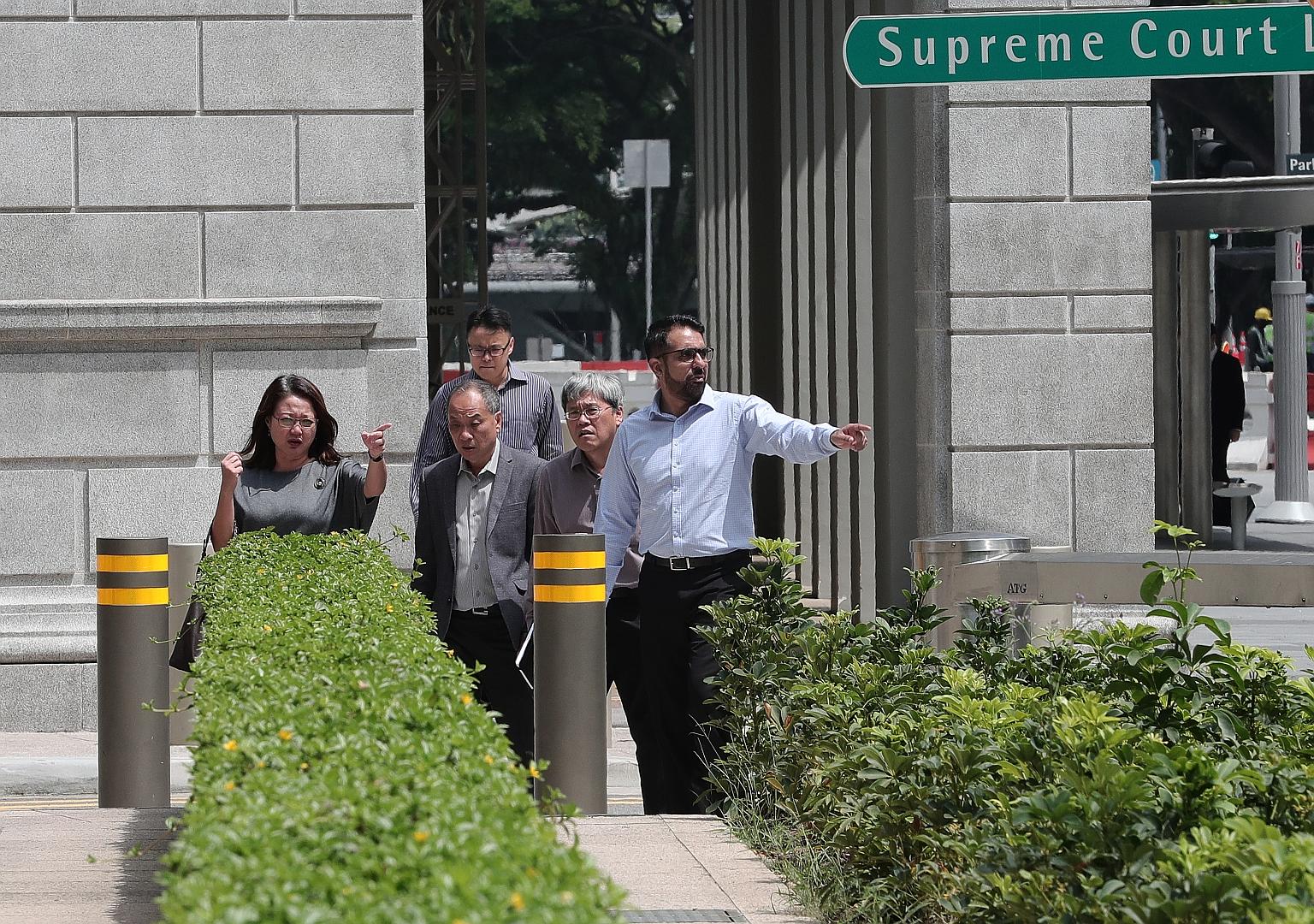(From far left) Workers' Party chairman Sylvia Lim, former WP chief Low Thia Khiang, WP MP Png Eng Huat and WP secretary-general Pritam Singh outside the Supreme Court yesterday. Senior Counsel Chelva Rajah sought to explain why CPG Facilities Manage