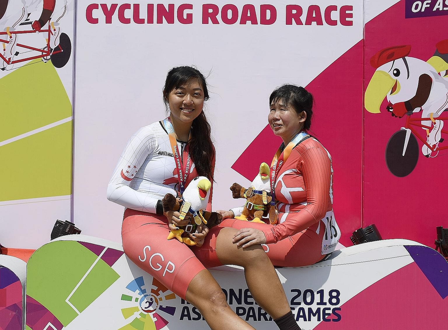 Pilot Sarah Tan and cyclist Emily Lee (far right) finished third yesterday in the Asian Para Games women's 72km road race B. They clinched Singapore's first cycling medal in the Jakarta Games. The Republic won three other medals yesterday through swi