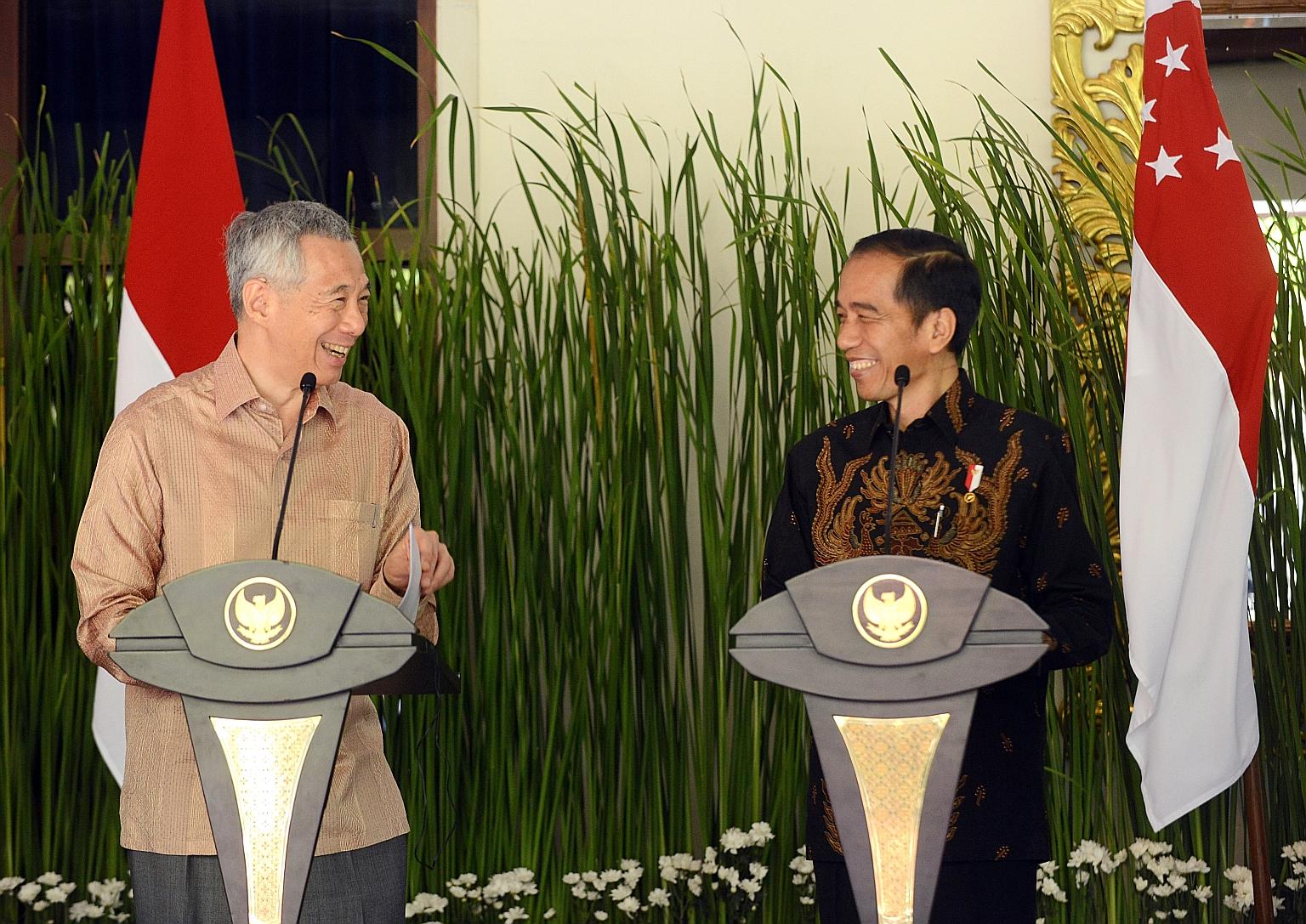 Prime Minister Lee Hsien Loong and Indonesian President Joko Widodo speaking to journalists after their bilateral meeting in Nusa Dua, Bali, yesterday. The leaders noted the mutual trust between the two countries, and said they could do more to benef