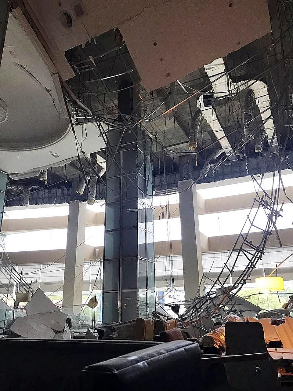 A worker (above) fell 12m and suffered head injuries after the plaster ceiling (right) collapsed during routine maintenance.