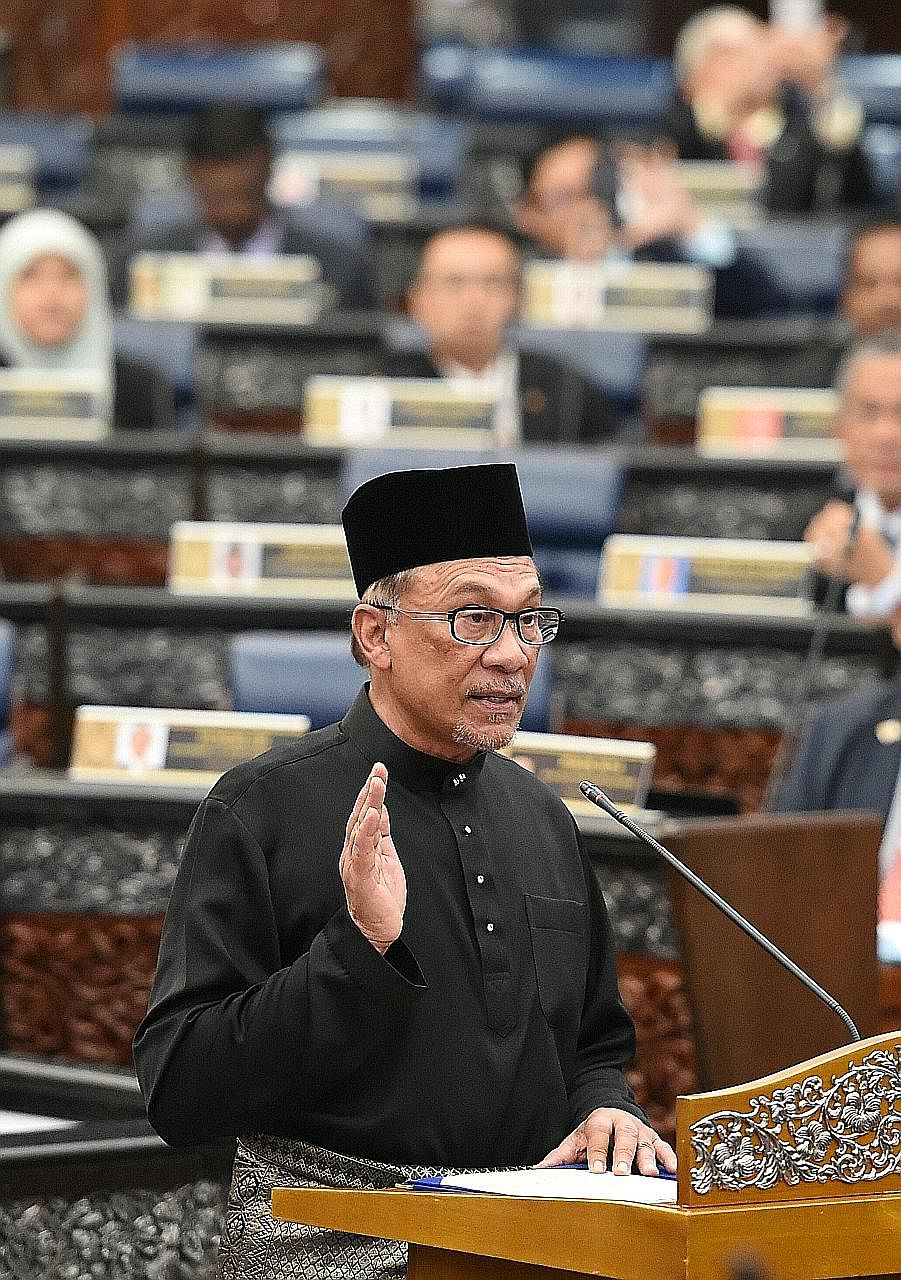 Datuk Seri Anwar Ibrahim taking the oath as a Member of Parliament during yesterday's swearing-in ceremony at Malaysia's Parliament House in Kuala Lumpur.