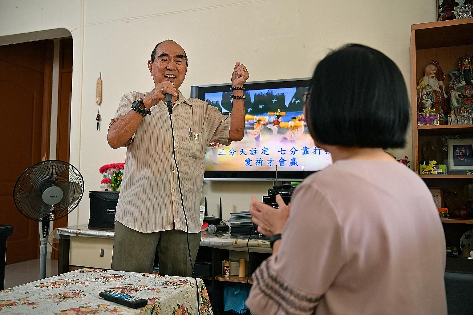 Mr Tay Tian Siang singing while his daughter Lian Choon claps along. Being single, she takes on the bulk of caregiving duties for her father.