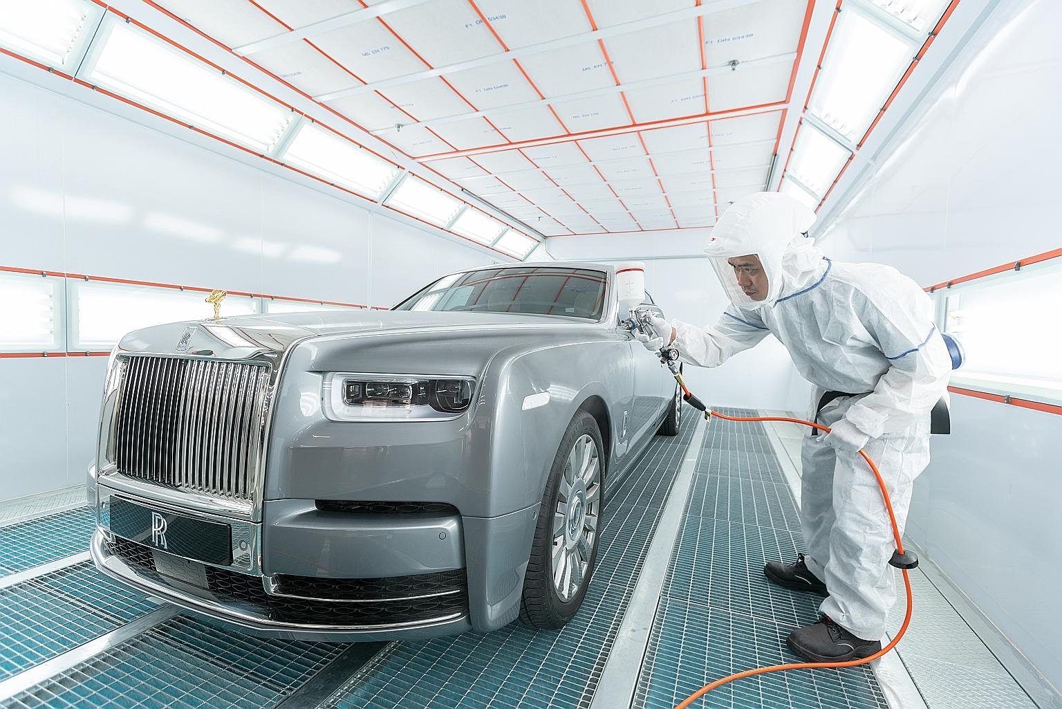 A Rolls-Royce limousine getting a paint touch-up in a dust-free paint booth at Eurokars' new $70 million integrated warehousing, servicing and car pre-delivery centre in Tanjong Penjuru, which will open next week.