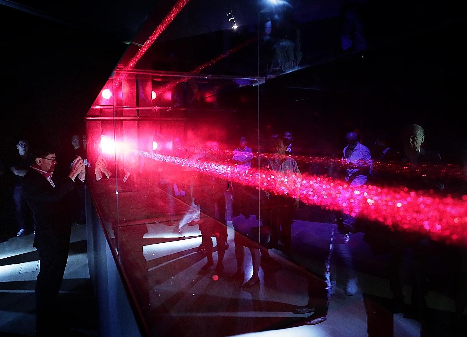 Finance Minister Heng Swee Keat viewing an exhibit - Quark IV by artist Eiji Sumi - at the All Possible Paths: Richard Feynman's Curious Life exhibition at the ArtScience Museum yesterday.