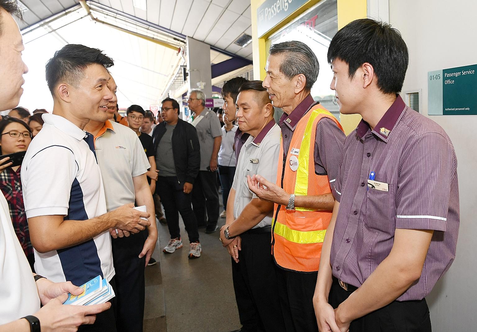 Mr Baey Yam Keng (at far left) speaking to public transport workers from SBS Transit at Tampines Bus Interchange after the launch of the Public Transport Workers' Appreciation Campaign yesterday.
