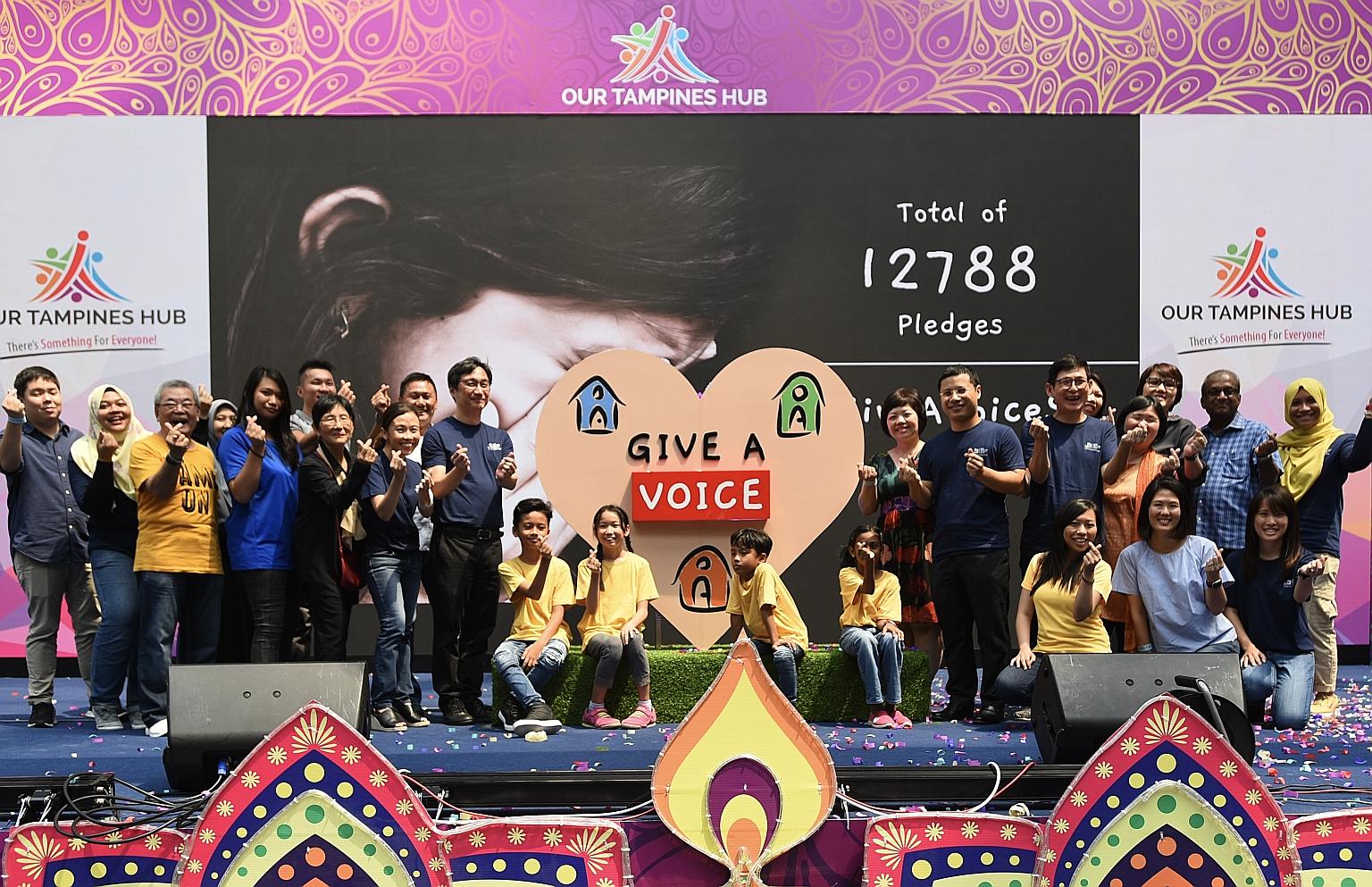 Minister for Social and Family Development Desmond Lee (standing, seventh from right) at a carnival in Our Tampines Hub yesterday to celebrate Big Love Child Protection Specialist Centre's fifth anniversary.