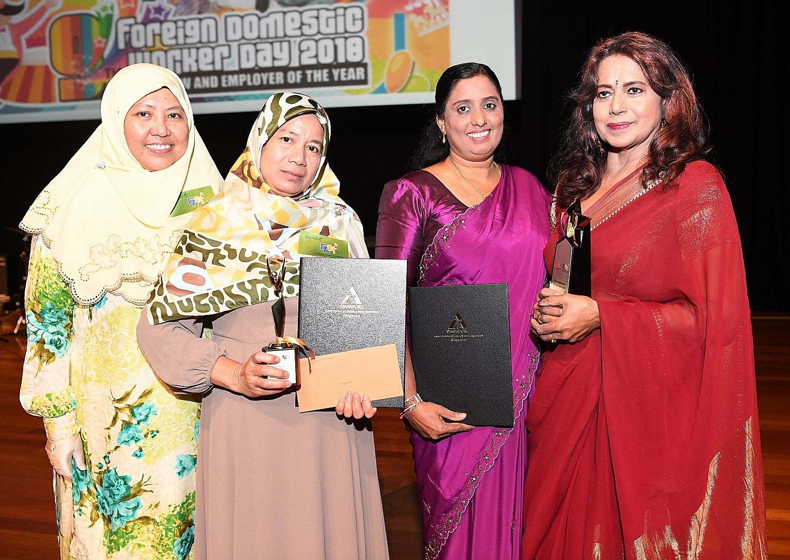 (From left) Employer Umi Saleha with her FDW Sri Wahyuni, who won the FDW of the year award; and FDW Sasenthu Kankanamge Suneetha Iranganie with her employer Bhamah Ramdas, who won the FDW employer of the year award, at yesterday's Foreign Domestic W