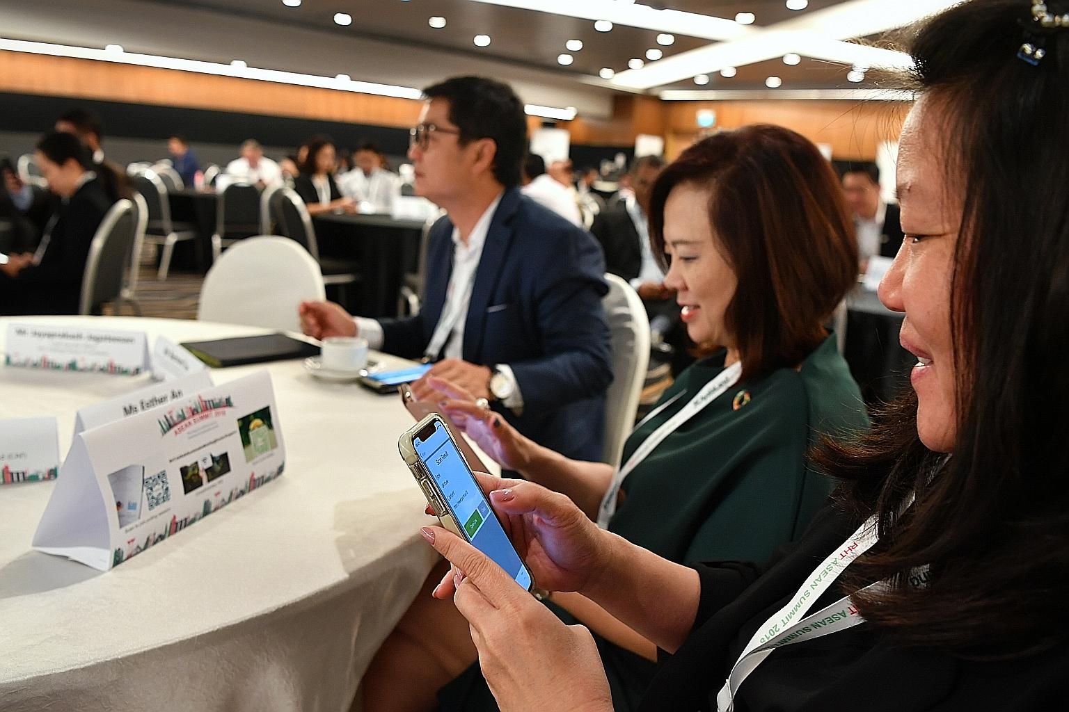 Participants at the RHT Asean Summit signing the climate action pledge, promising to work towards reducing their carbon footprints.