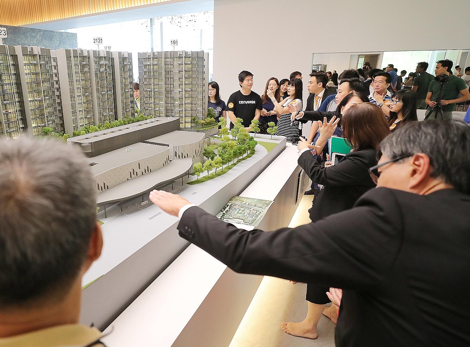 People viewing a model of The Woodleigh Residences at the soft launch yesterday. Sales for the mixed-use commercial and residential development have not begun and visitors to the showroom said they were keen to return when sales start on Nov 10.