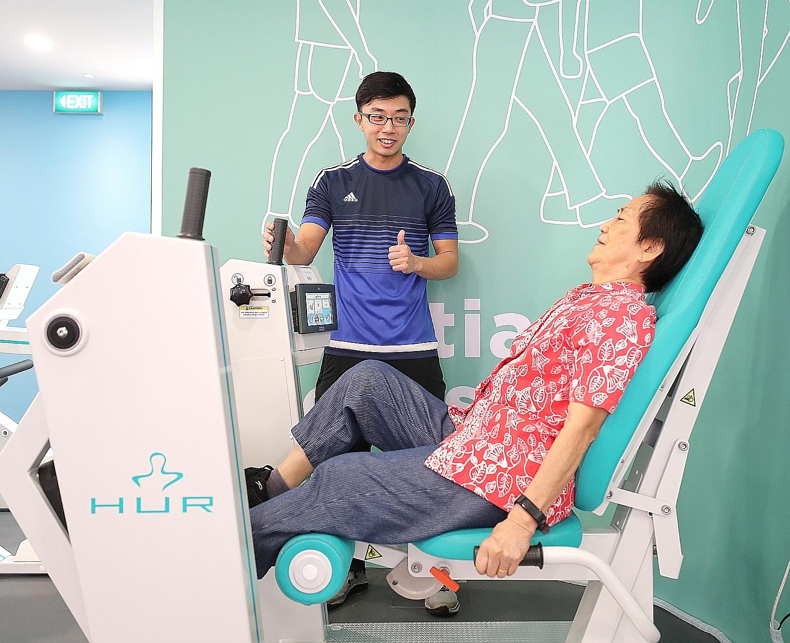 Madam Tee Ah Lui doing the Gym Tonic programme under the guidance of wellness coach Joseph Chan at Bishan Community Club yesterday. The programme at the club started in April, and 149 senior citizens have completed the programme so far.