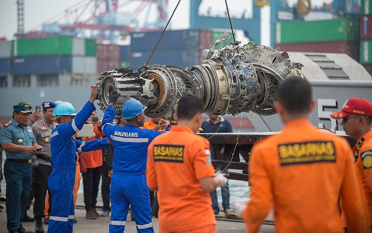 Indonesian rescue personnel unloading a recovered engine yesterday from the ill-fated Lion Air Flight JT610 at a port in Jakarta. As of yesterday, a total of 105 body bags had been recovered and handed to police for forensic identification.