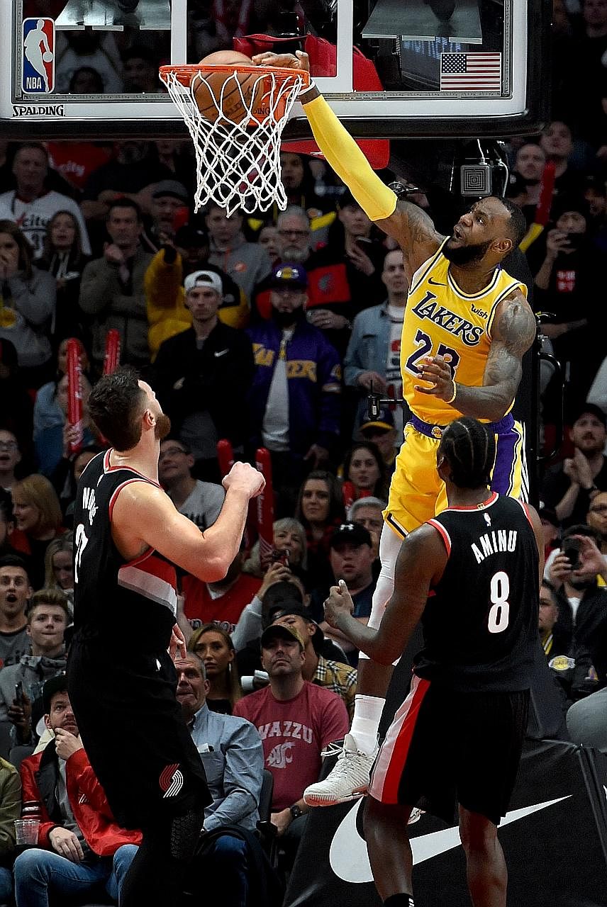 Los Angeles Lakers star LeBron James dunking the ball on Portland Trail Blazers centre Jusuf Nurkic in the second half of Saturday's game. The Lakers won 114-110, after having lost 16 straight games against the Trail Blazers.