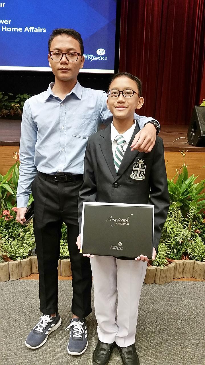 Secondary 4 student Muhammad Darwisy Iskandar, 16, and his Secondary 1 brother Muhammad Daiyan Iskandar both got into St Joseph's Institution through the Direct School Admission scheme.