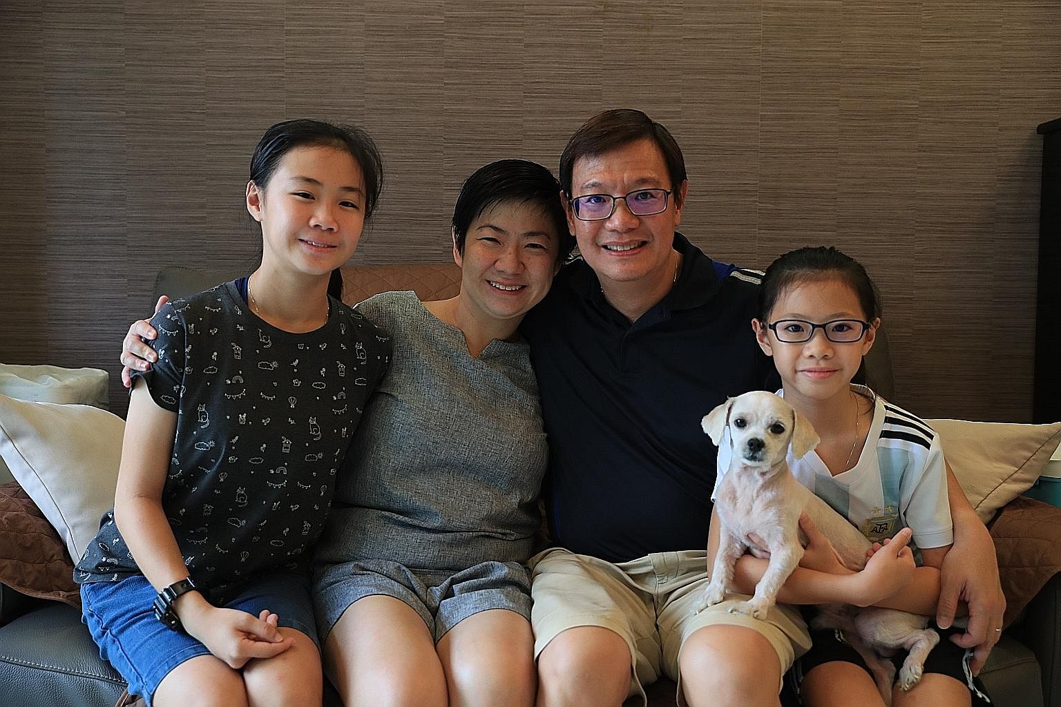 Ms Low relaxing at home with her husband Francis Tang and daughters Juliet (left) and Emily, and their family dog. Ms Low attending the Convention on the Rights of Persons with Disabilities at the UN headquarters in New York in 2015. She lost her hea