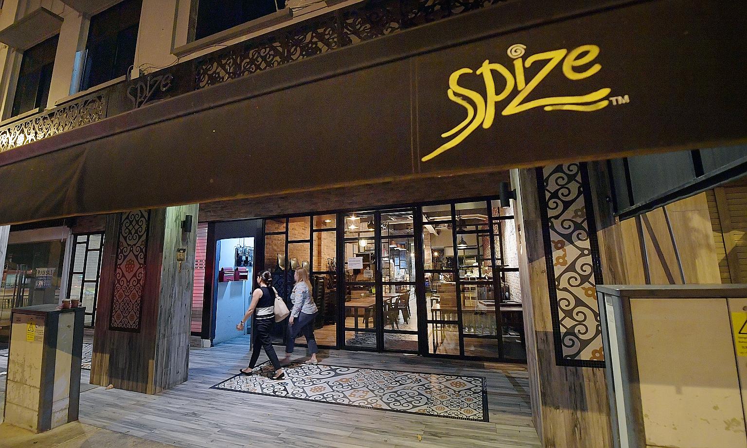 Father of two Fadli Salleh, who died after being in critical condition, was buried yesterday. Spize's River Valley outlet (right) has been suspended until further notice, and staff there have not been redeployed.