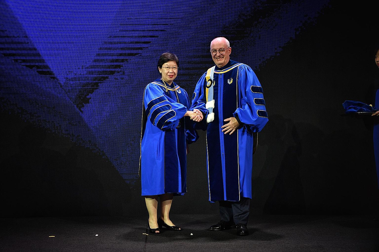 Singapore Management University's outgoing president Arnoud De Meyer and his successor, SMU provost Lily Kong, at a farewell ceremony for the 64-year-old don last night.