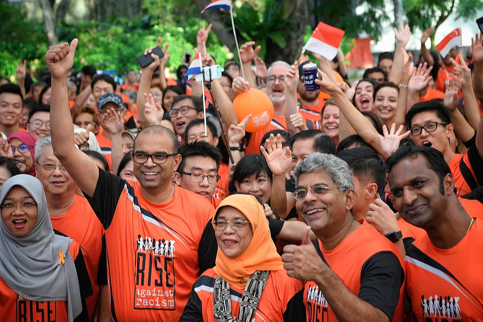 Close to 3,000 people showed up in support of the Rise Against Racism campaign yesterday at the Orange Ribbon Walk. They walked 3.8km around the Marina Bay area, accompanied by President Halimah Yacob (front, centre), who flagged off the walk at Espl